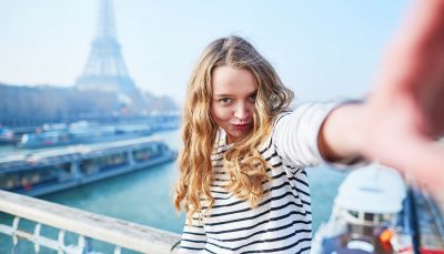 A woman talking a selfie near Eiffel tower, Paris